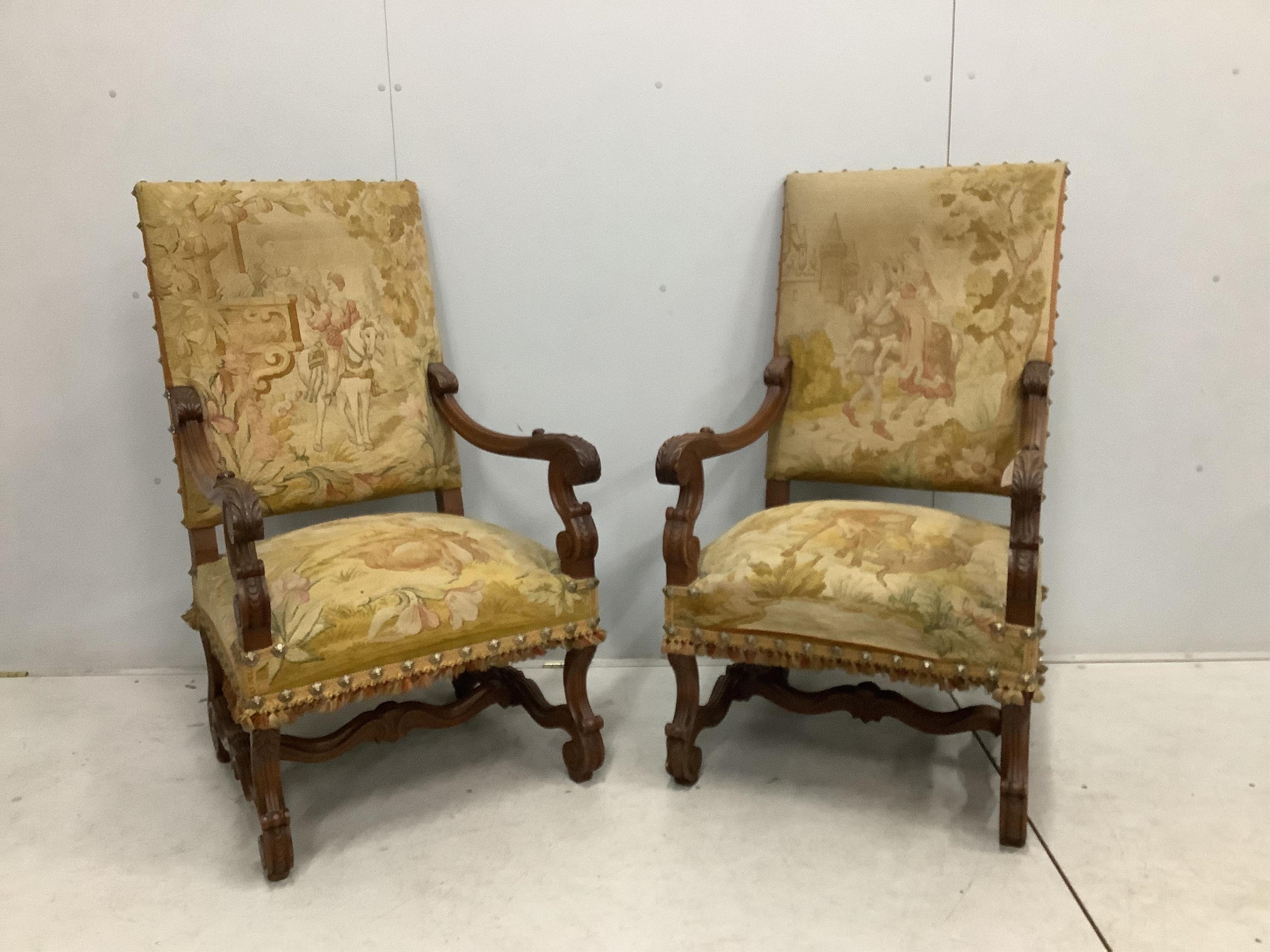 A pair of 18th century style walnut and needlepoint tapestry chairs, width 63cm, depth 64cm, height 114cm. Condition - fair